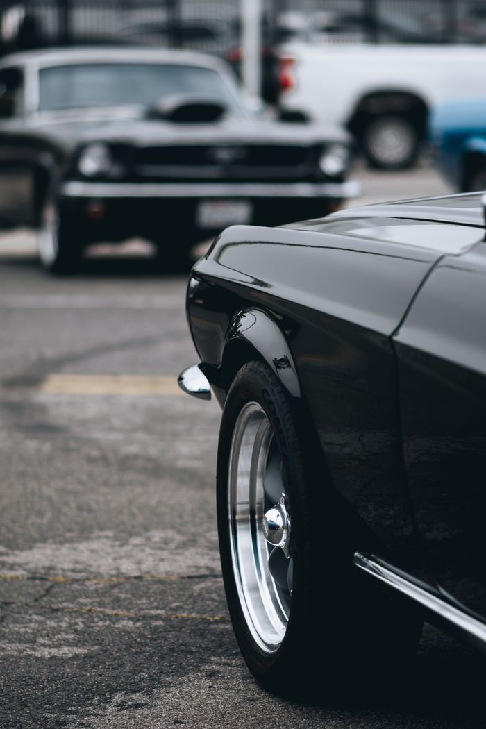 Offerings Close-up of vintage American muscle cars parked outdoors, showcasing classic design.