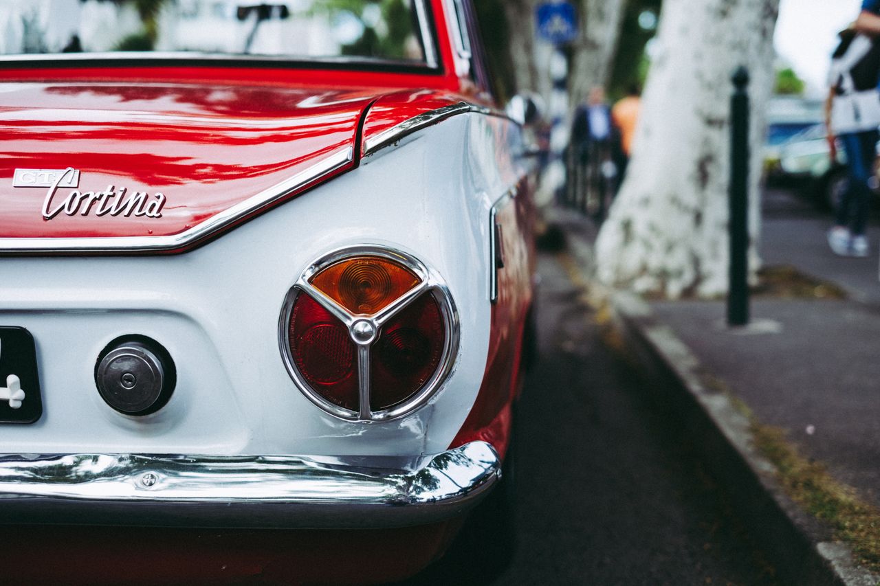 The Art of Drawing Readers In: Your attractive post title goes here Close-up of a vintage red Cortina car parked on a street showing its classic design.